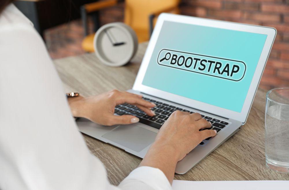 Person Looking Up Bootstrapping On Laptop