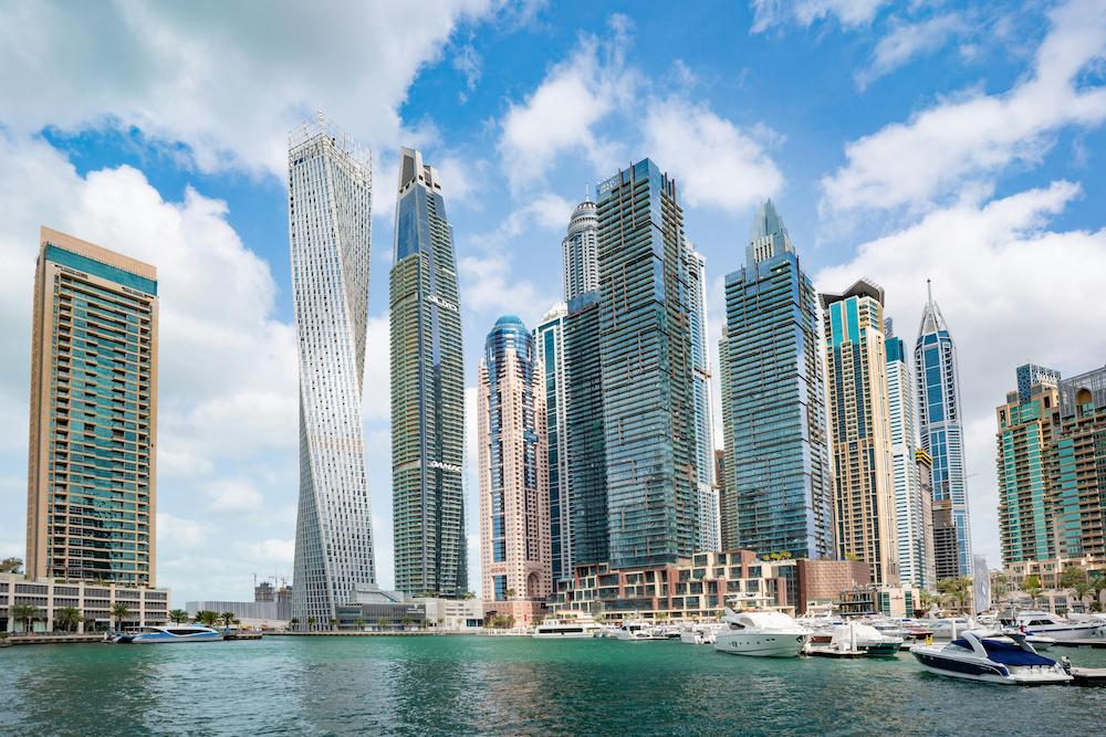 Dubai, the ideal location for business expansion, by day showing high rise buildings on the water