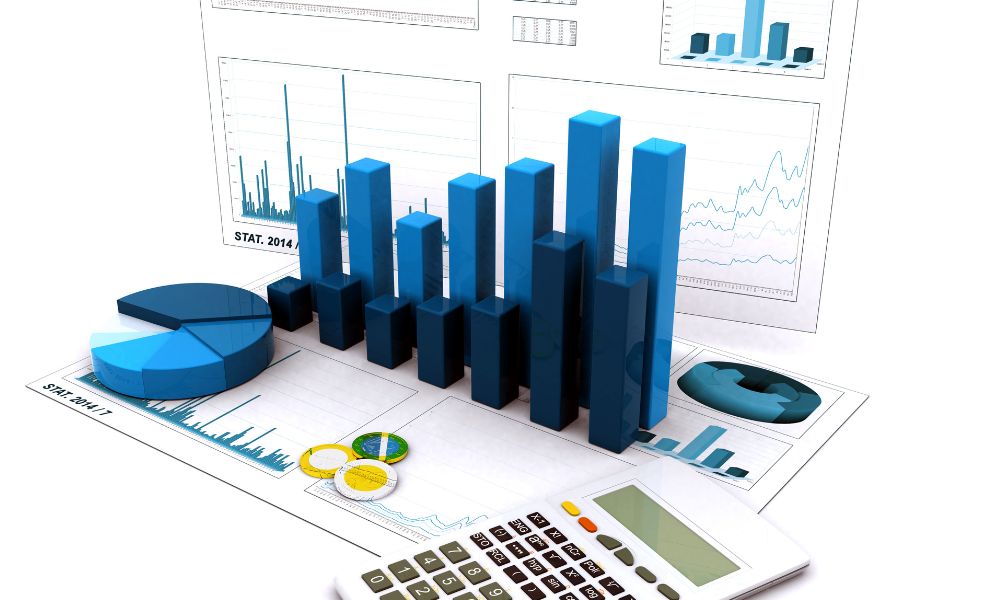 Graphs On Desk With Calculator