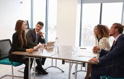 Business professionals discussing a professional licence in Dubai during a company setup meeting.