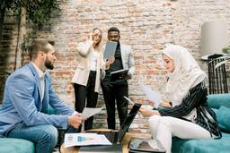 Multicultural business team reviewing company setup documents for a Dubai free zone business.
