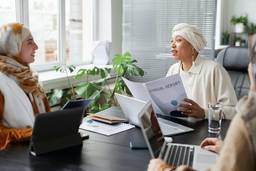 Free Women in a Business Meeting Using A General Trading Licence Stock Photo