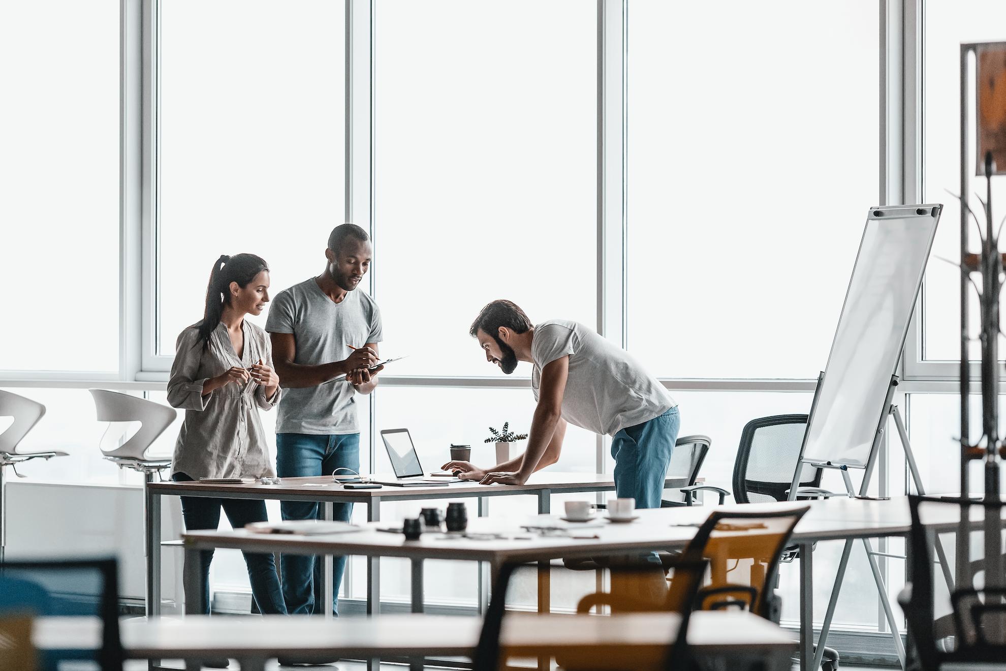 Entrepreneurs collaborating on small business ideas in a modern UAE co-working space.