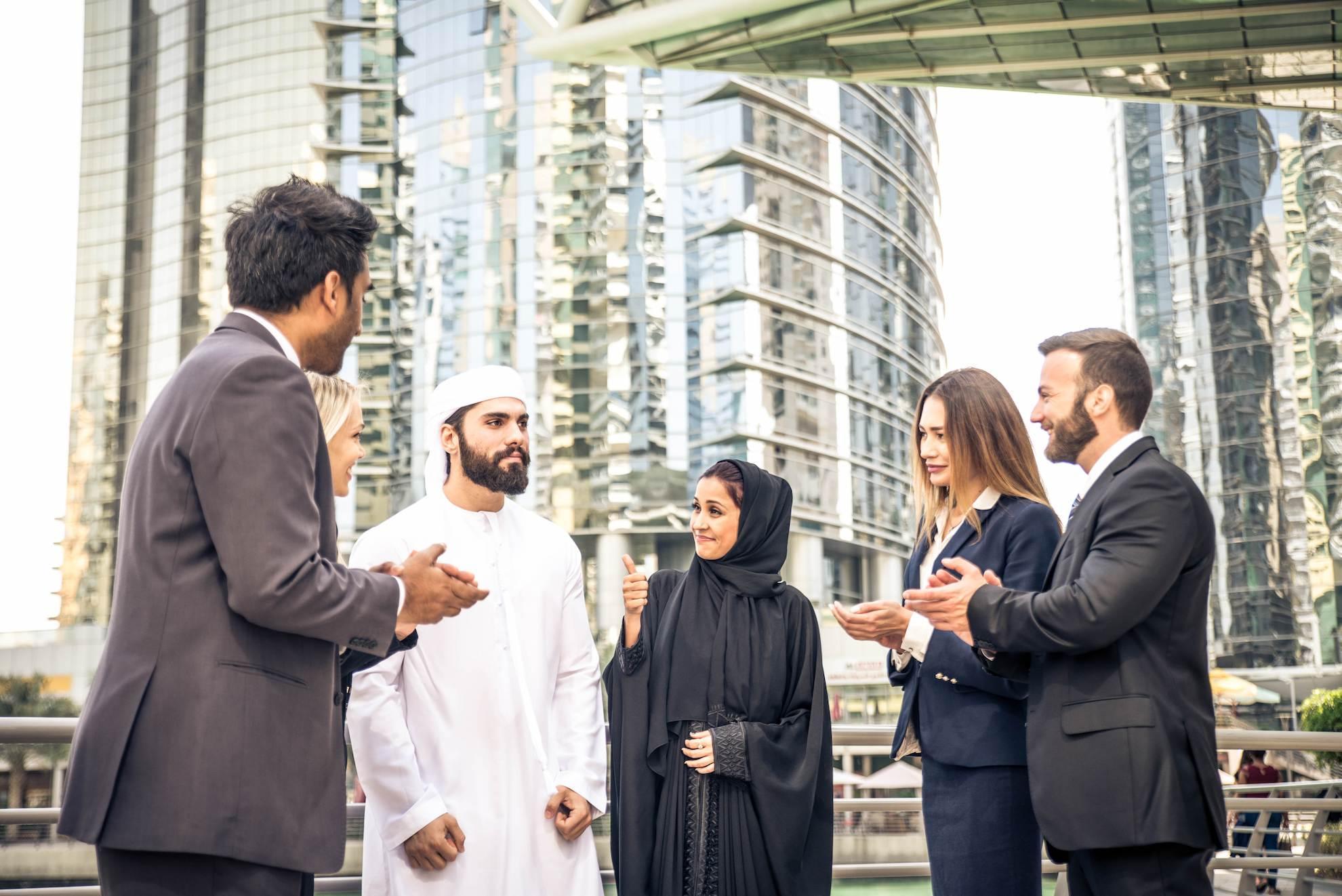 Business professionals in Dubai discussing NOC requirements for UAE company setup.