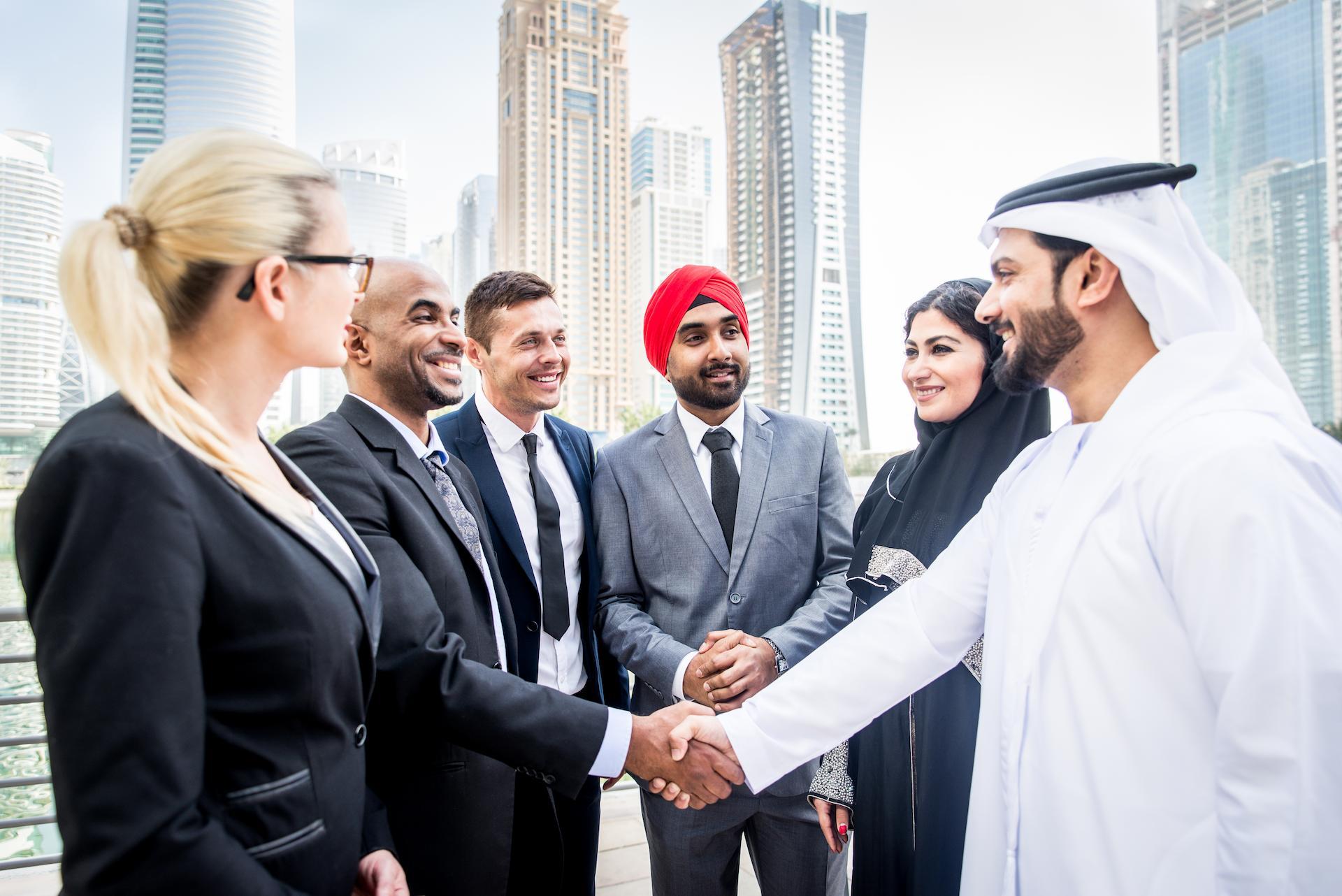 Multicultural group of business people shaking hands after a winning sales strategy