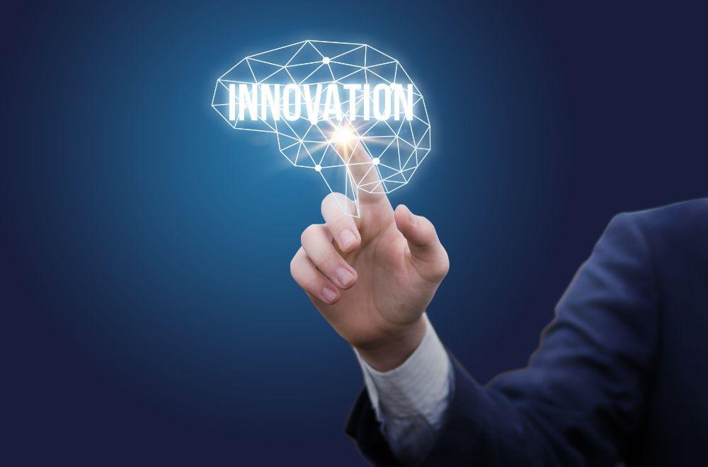 Business Man Pointing To Word "Innovation"