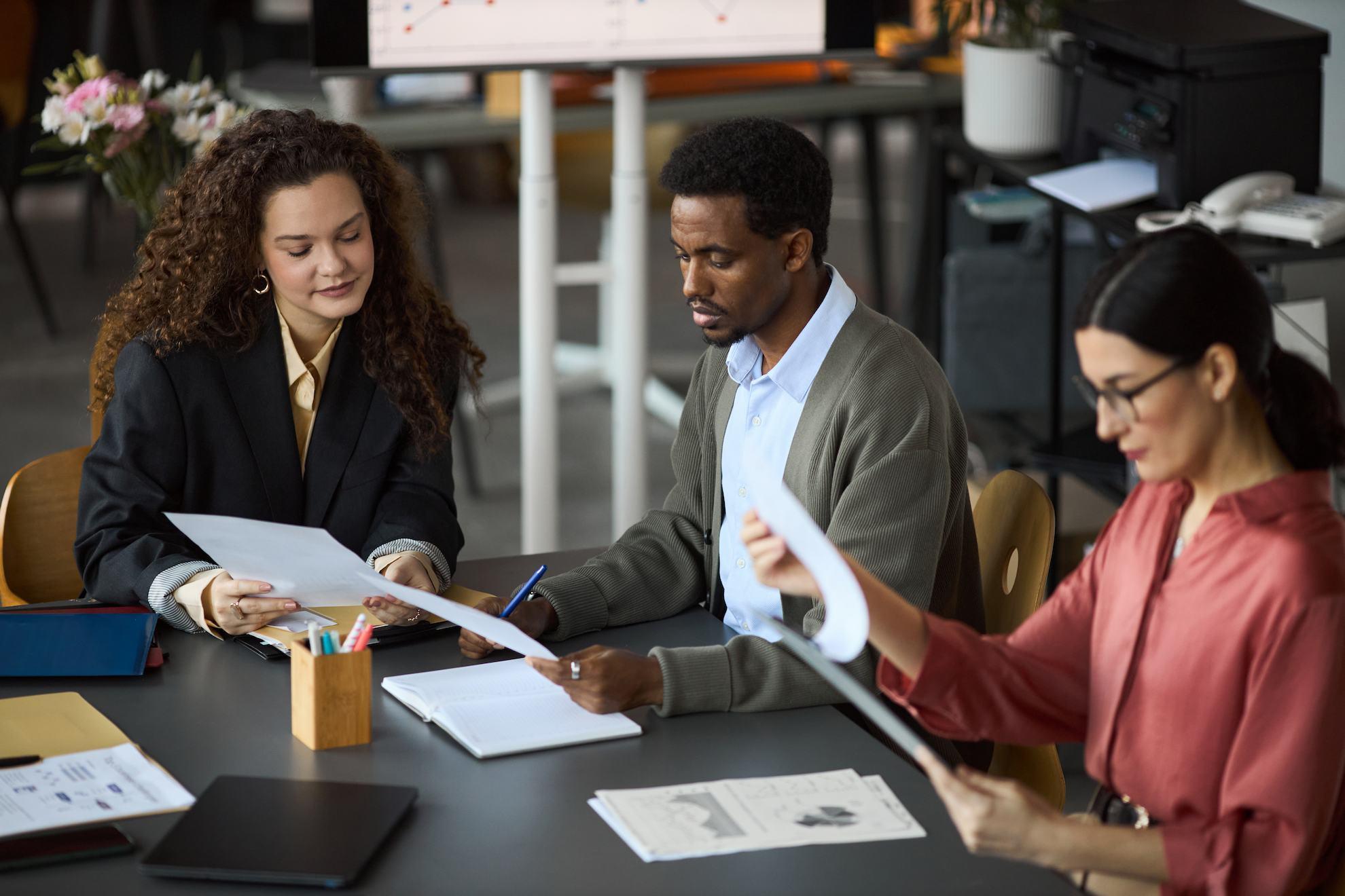 Business team reviewing documents for a UAE holding company setup.